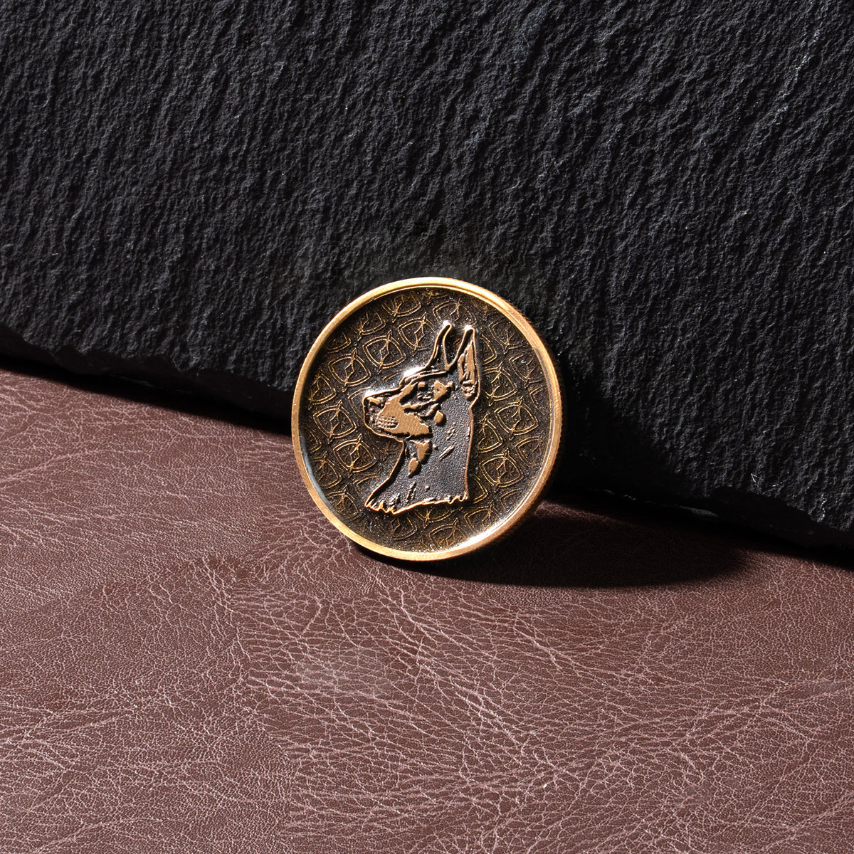 Deep-relief brass coin featuring a Doberman Pinscher